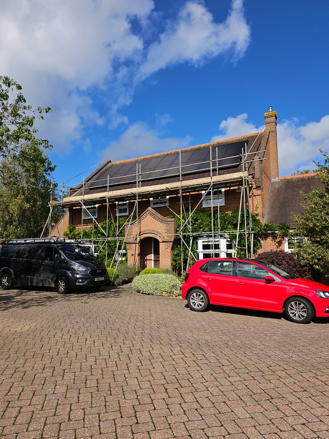 Henson Installations van and team completing solar panel installation on large UK home